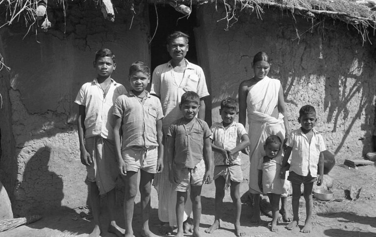 Sukuram Champia’s family. He was our landlord and we shared the same courtyard. From left to right, Bisu, Bamiya, Selai, Lal, the mother Pelon, Besera and Basu, all dressed in their best clothes for this formal photo. They owned our house and were our immediate neighbours.